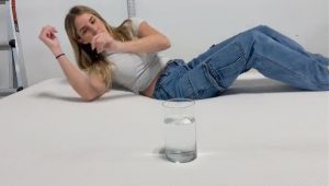 A woman moves near a glass of water on the Boring AF mattress