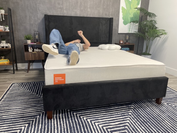 Our tester rolling around on a Boring Hybrid Mattress
