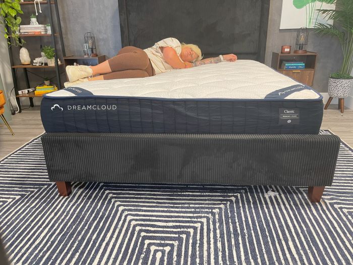A woman lays on her side on the DreamCloud Memory Foam mattress