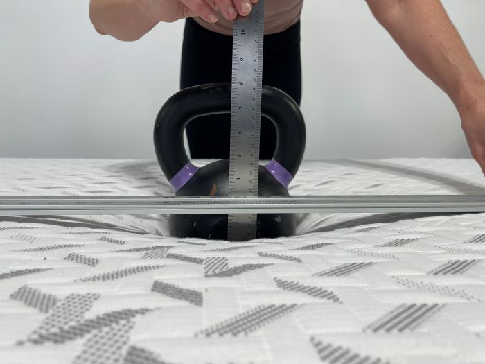 A kettlebell measures sinkage on the Nectar Classic Hybrid mattress.