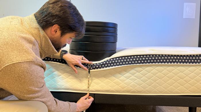 Measuring weight plates on the edge of the WinkBed Plus Mattress