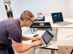 Melanie taking pressure map readings of the Plank Firm Mattress 2