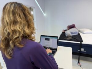 Our testers using the pressure relief mat on a Brooklyn Bedding Aurora Luxe Cooling Mattress