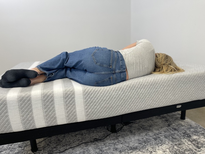 Testing edge support on the Leesa Original mattress by lying down close to the side