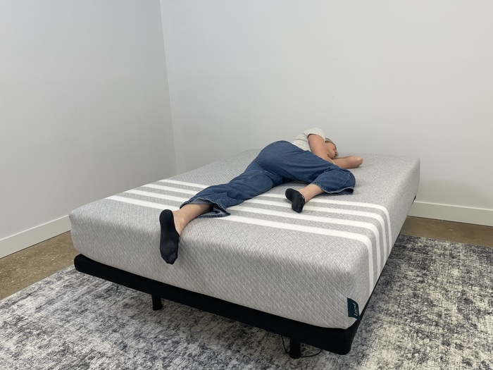 A tester resting on her side on the Leesa Original mattress