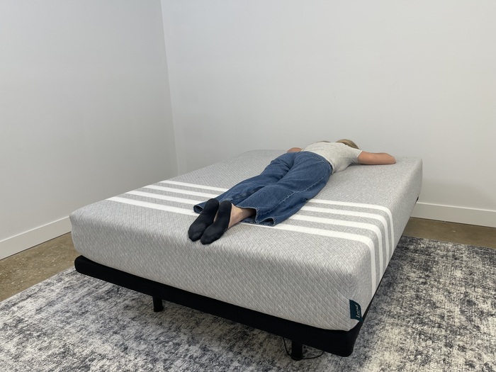 A tester resting on her stomach on the Leesa Original mattress
