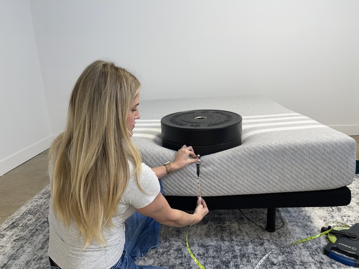 Measuring sinkage from placing weight plates on the edge of a Leesa Original Mattress