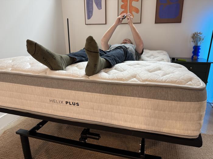 Our tester takes decibal readings while operating the Brooklyn Bedding Ascension Luxe Adjustable Base