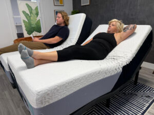 Two people resting on a Nectar Premier Adjustable Base with Nectar Premier Split King Mattresses