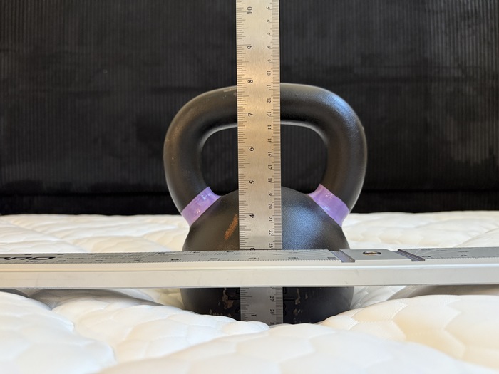 Testing sinkage on the Titan Plus Core mattress with a kettlebell