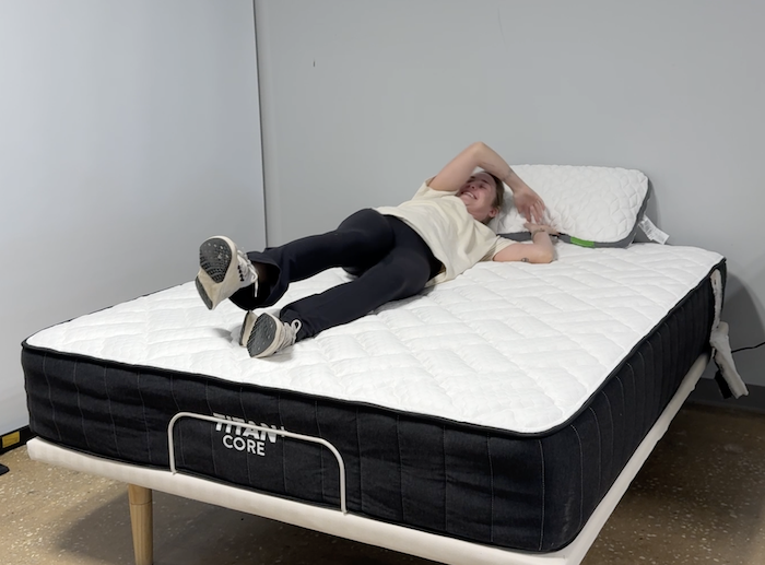 Testing responsiveness by rolling around on the Titan Plus Core mattress