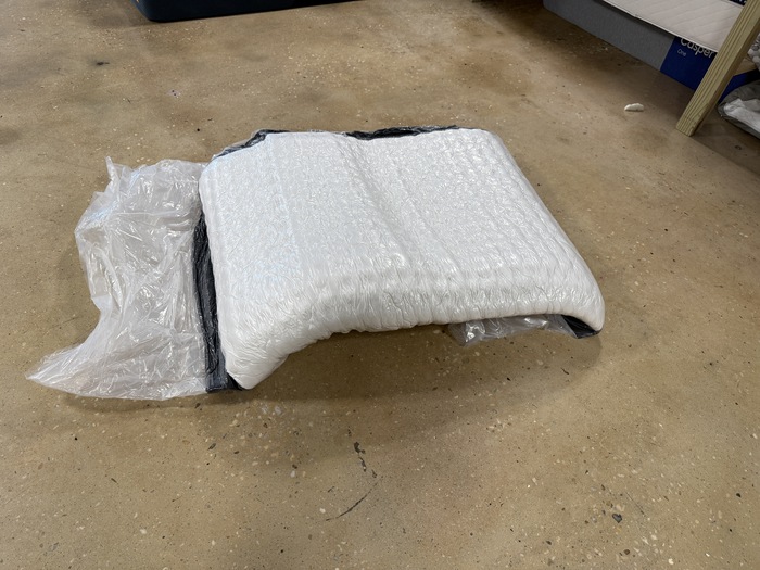 The Titan Plus Core mattress still wrapped in plastic after being unboxed