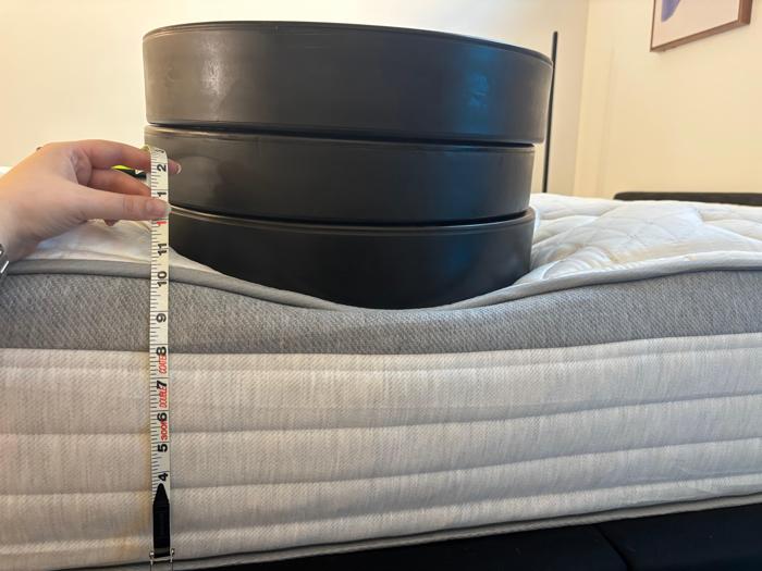 Measuring weight plates on the edge of the Helix Plus Mattress