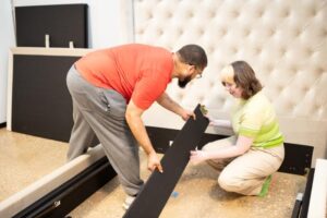 Our testers assembling the Saatva Amalfi Storage Bed Frame